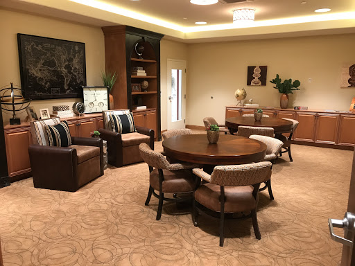 A cozy and elegantly designed living room featuring a wooden dining table, comfortable chairs, and tasteful decor.