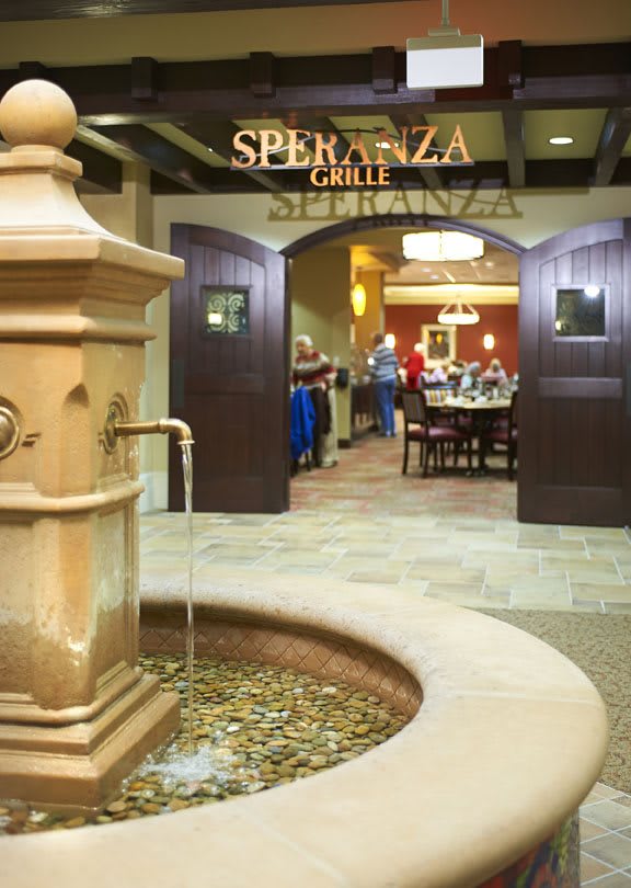 Entrance to Speranza Grille featuring an elegant fountain and inviting dining area.