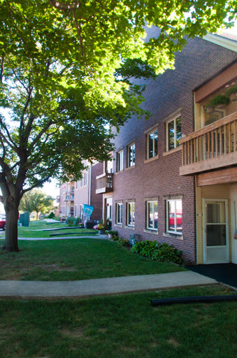 A serene view of a residential apartment building surrounded by greenery.