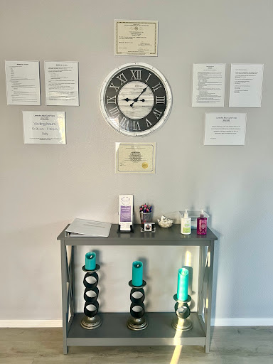 A wall displaying a clock and various documents, complemented by a shelf of assorted products.