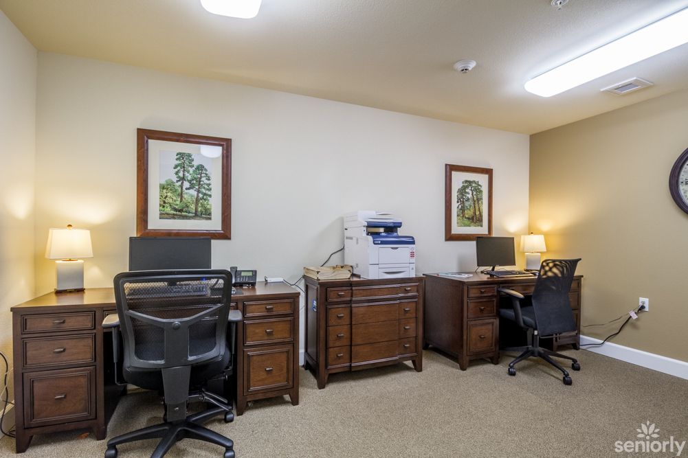 A well-organized office space with desks, computers, and a printer.