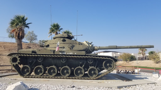A military tank parked in an outdoor setting, showcasing its robust design.