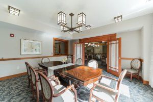 A well-lit dining room featuring elegant furniture and modern decor.