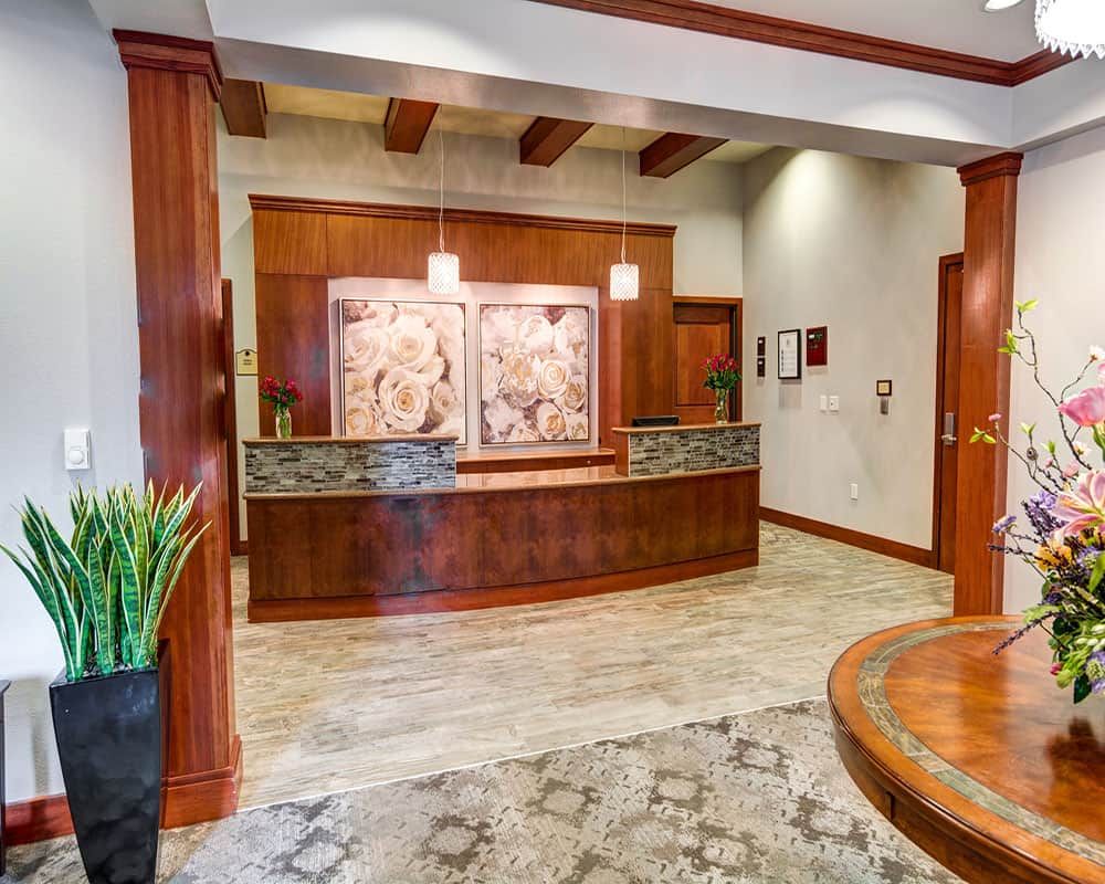 A welcoming hotel lobby with a wooden reception desk and stylish decor.