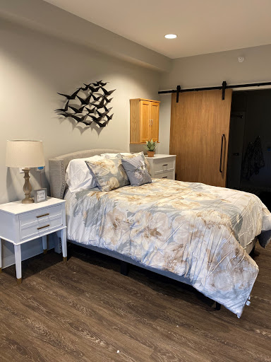 A beautifully designed modern bedroom featuring a cozy bed with stylish bedding and contemporary wall art.