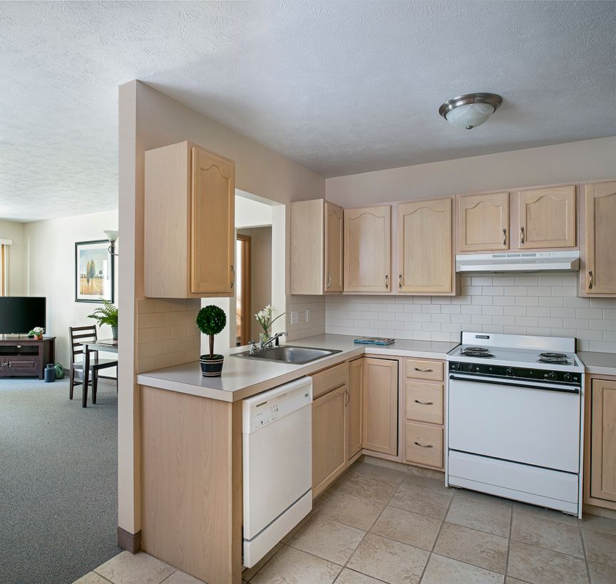 Modern kitchen interior in an apartment with wooden cabinets and appliances.