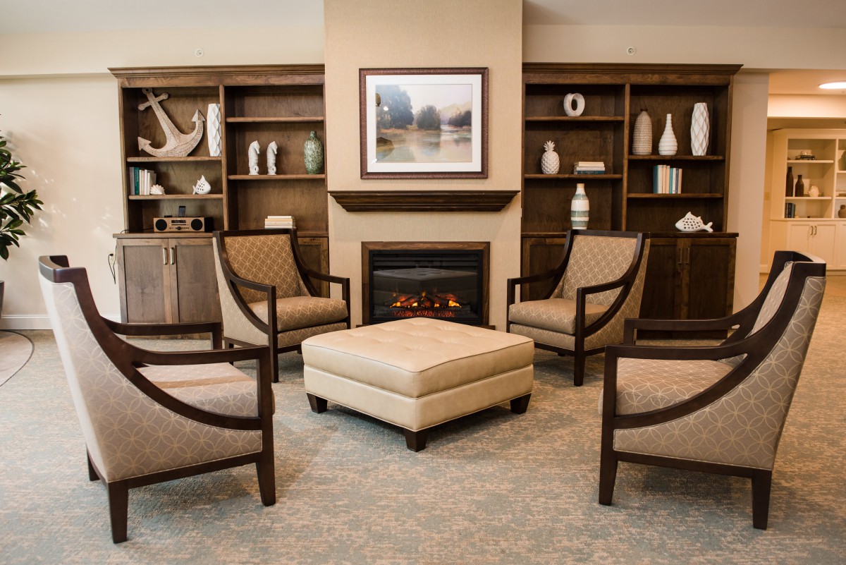 A cozy living room with elegant furniture and a warm fireplace.