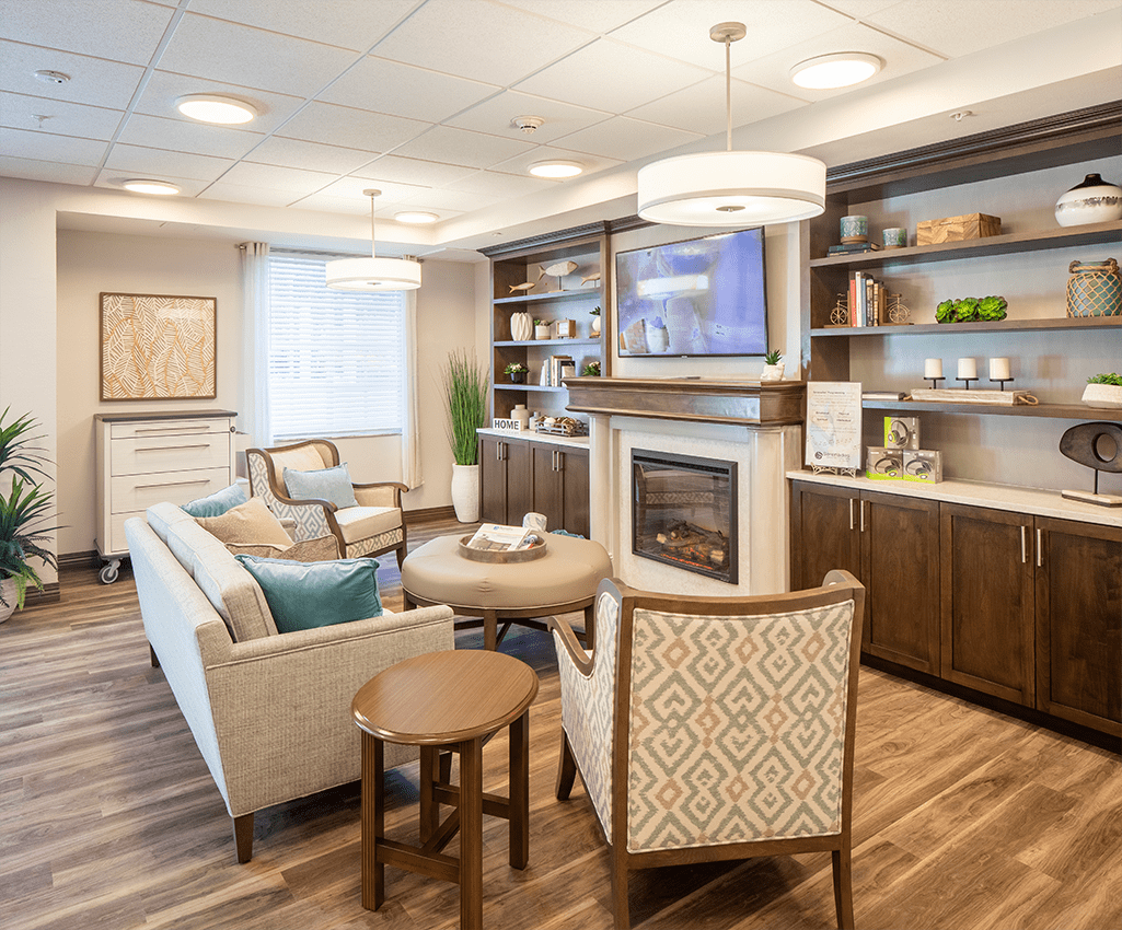 A modern and cozy living room with comfortable seating and a fireplace.