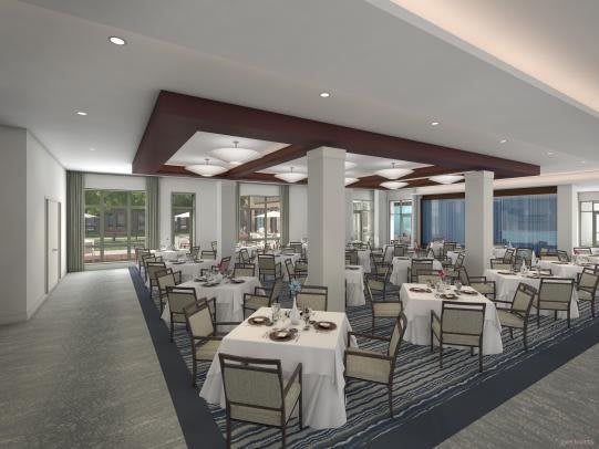 An elegant and spacious dining area of a restaurant, featuring neatly arranged tables and chairs.