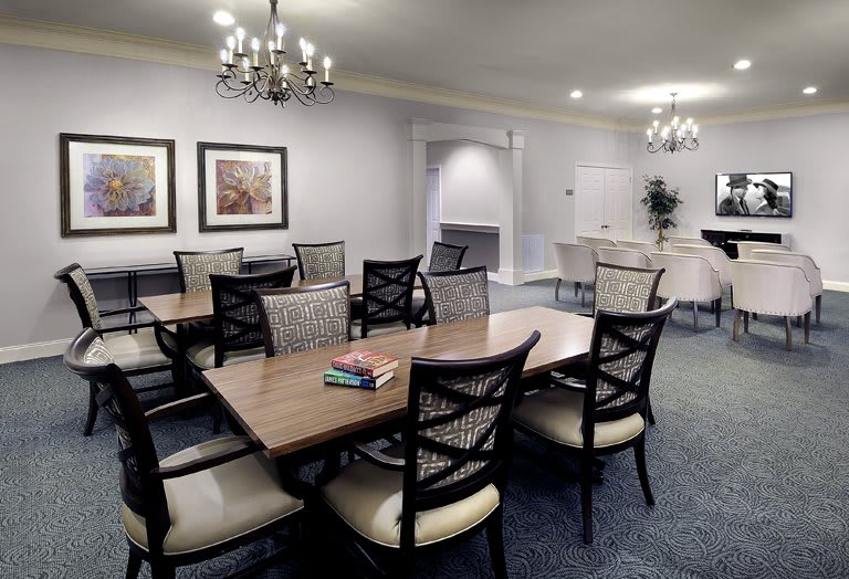 A well-appointed dining room featuring elegant chandeliers and comfortable seating.