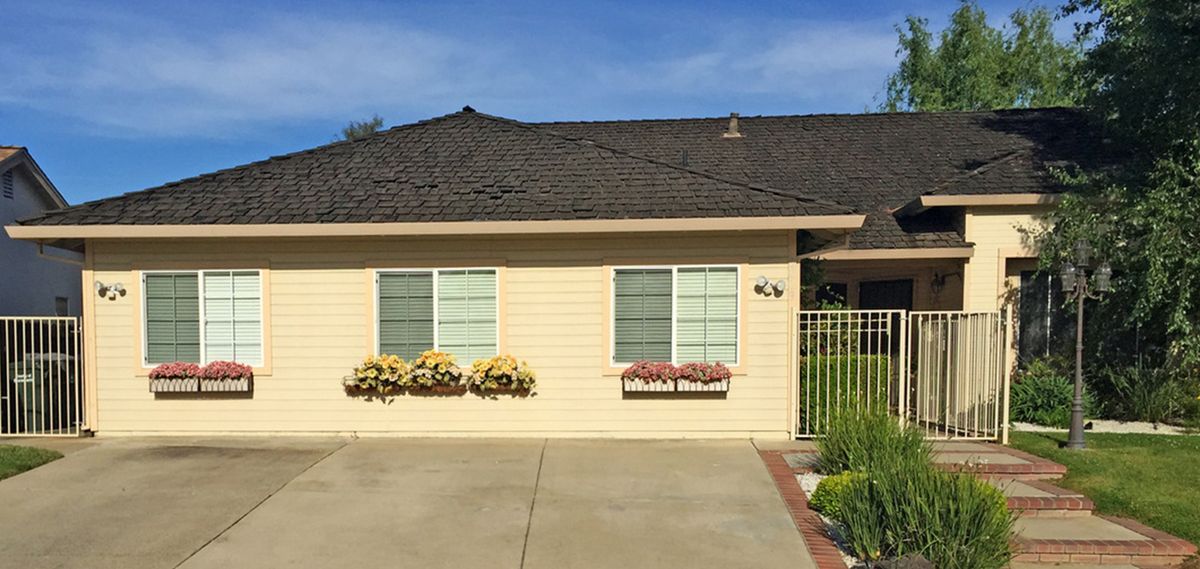 A single-story suburban house with window boxes and a driveway.