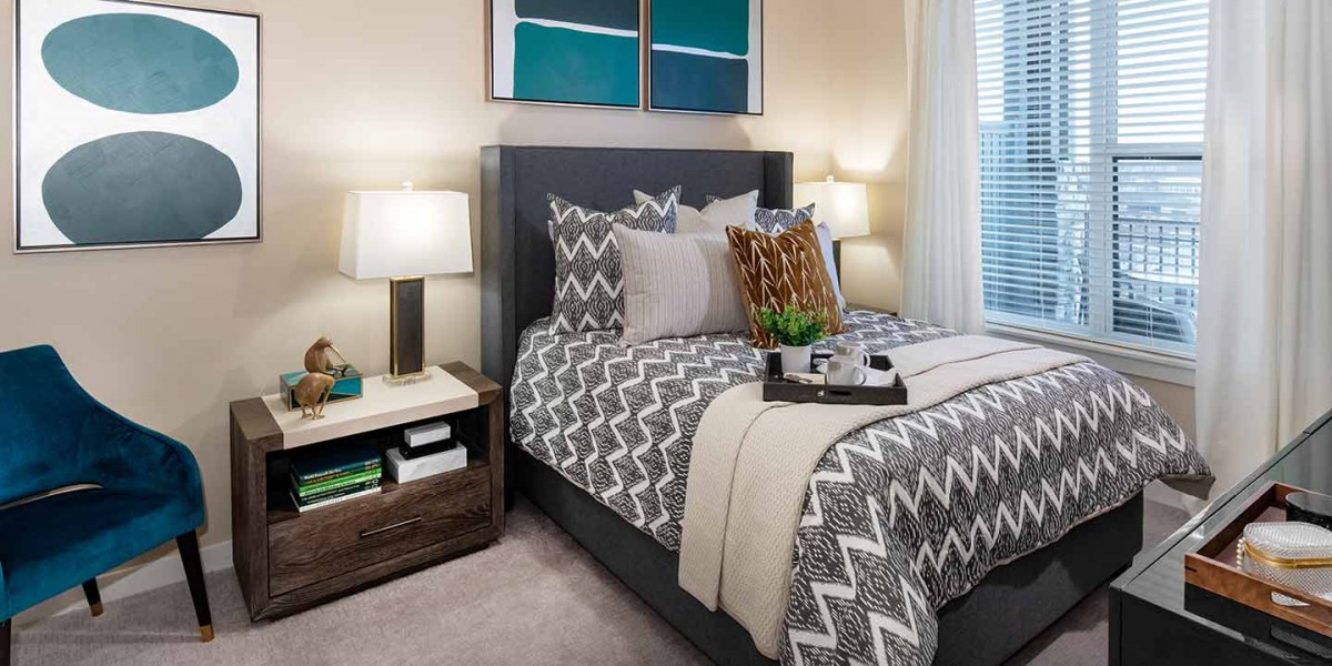 A modern bedroom with chevron-patterned bedding and stylish decor.