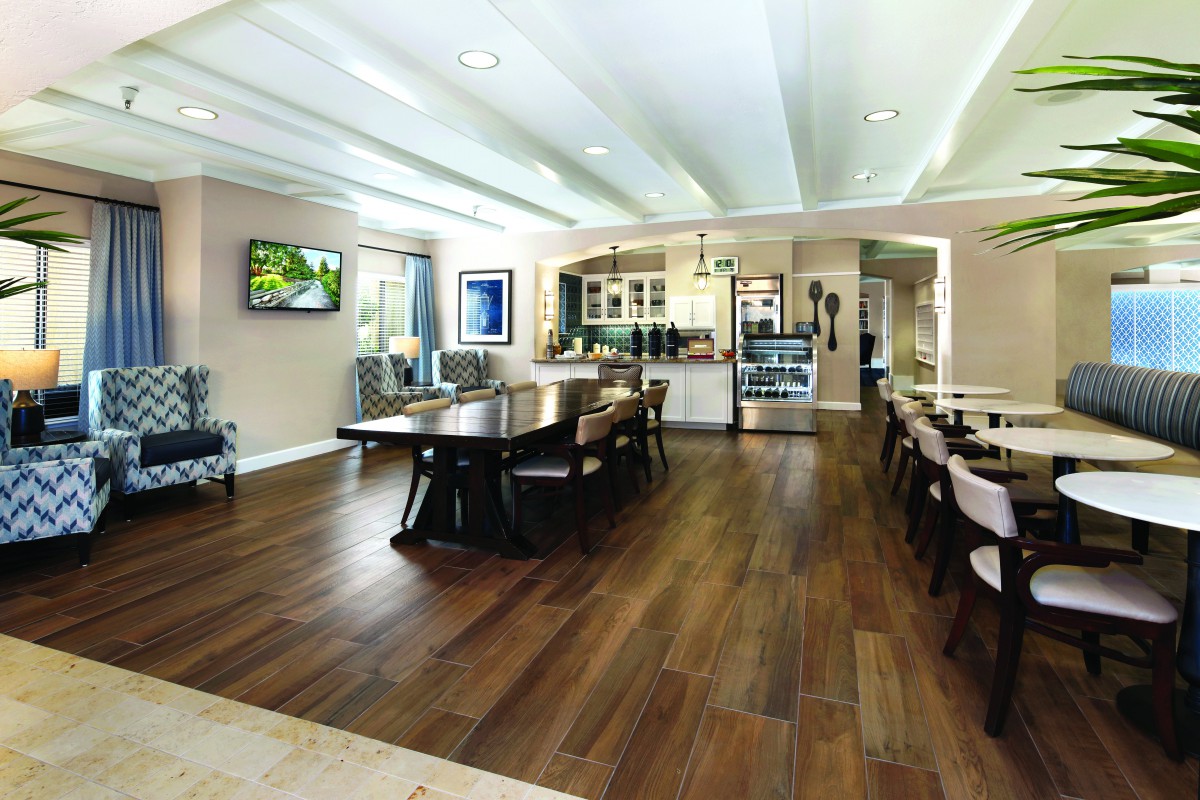 A spacious modern kitchen and dining area with wood flooring and contemporary furnishings.