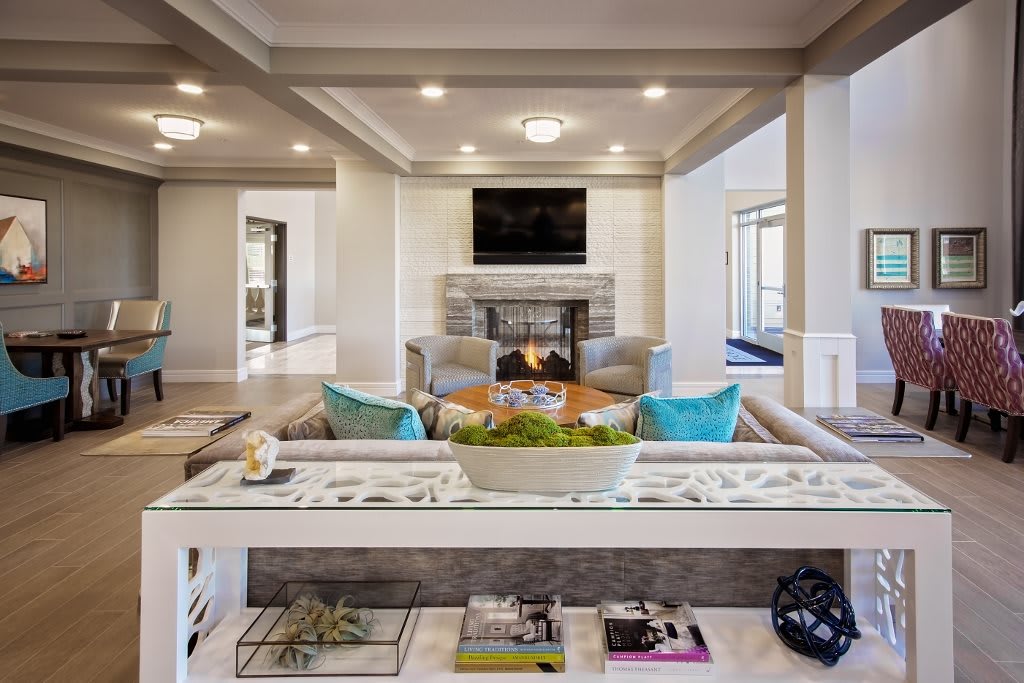 A modern living room featuring a cozy fireplace, stylish sofas, and a mounted television.