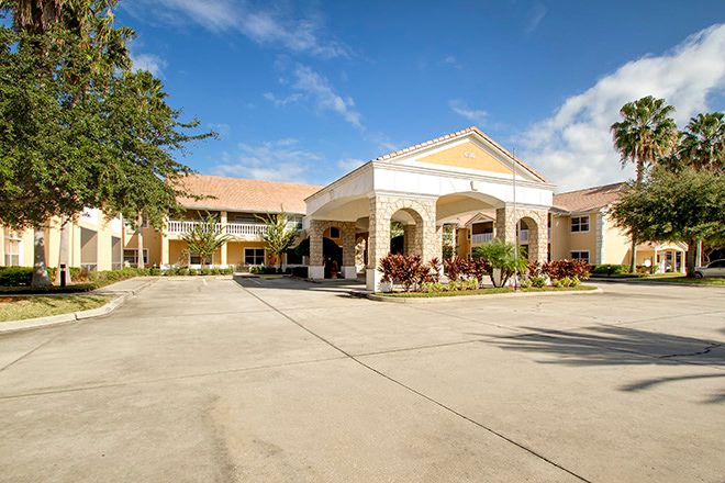 A hotel building with a welcoming entrance and clear blue sky.