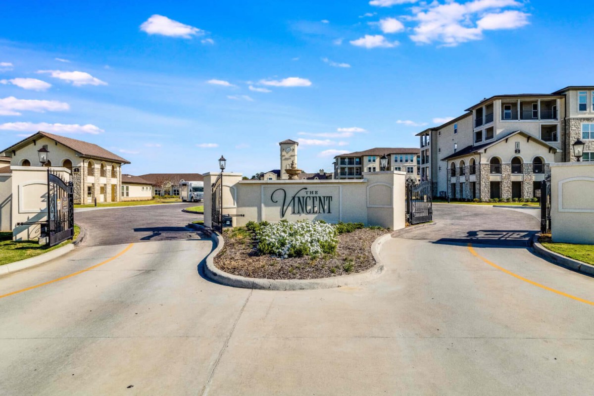 Exterior view of building entrance with fountain.