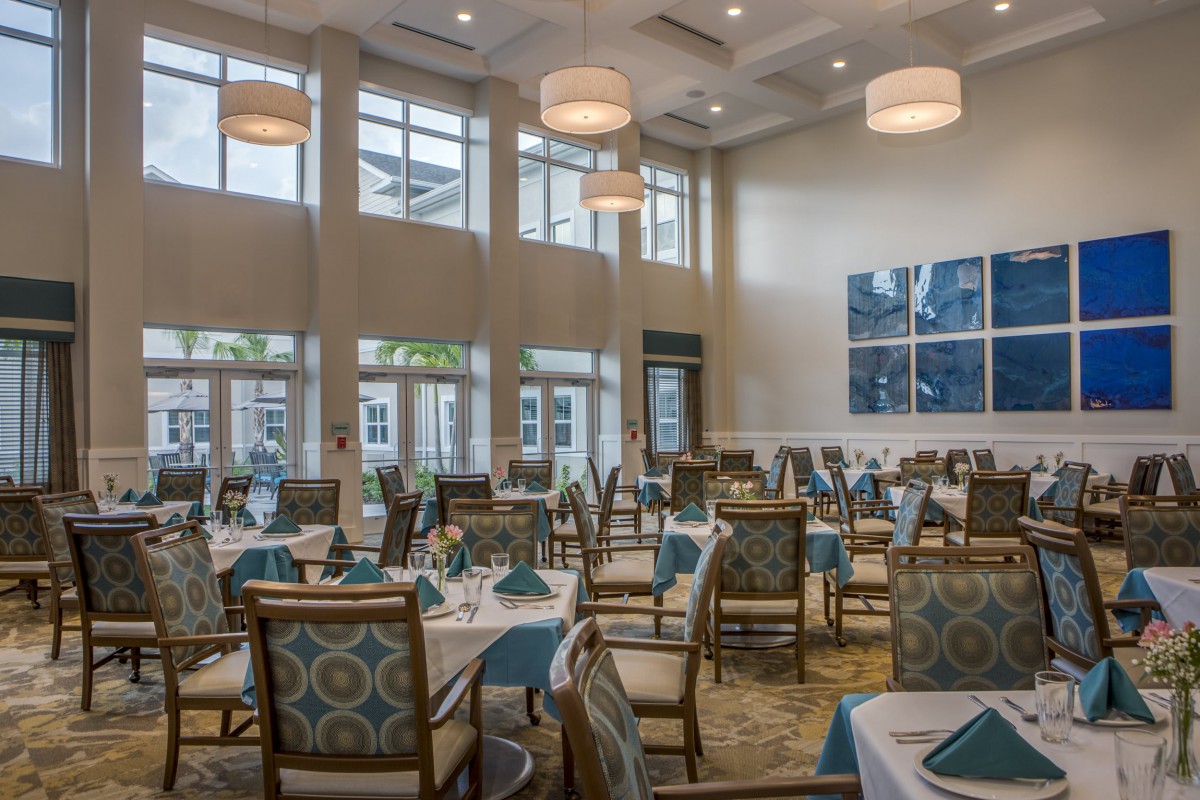 Elegant dining area with large windows and sophisticated decor.