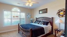 A cozy bedroom with elegant wooden furniture and stylish decor.