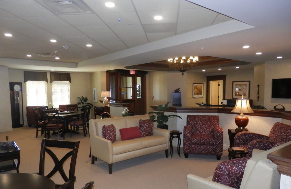 A spacious living room with elegant furniture and warm decor.