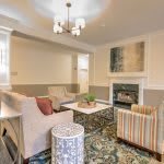 A cozy living room featuring a fireplace, comfortable seating, and elegant decor.