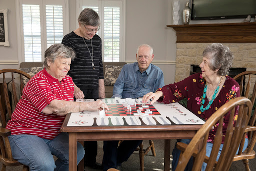 Seniors enjoying a lively board game session together.