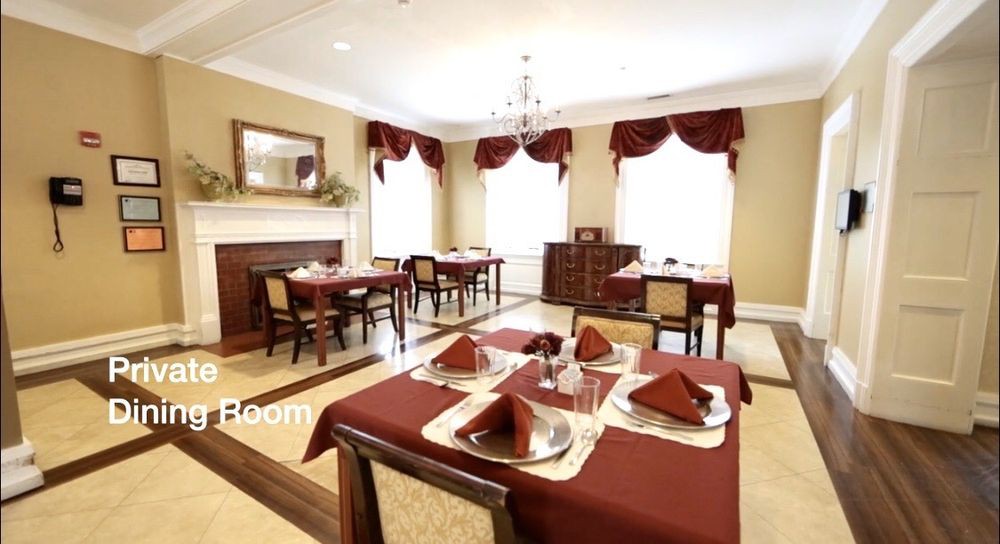 Elegant dining room with red table settings and classic decor.