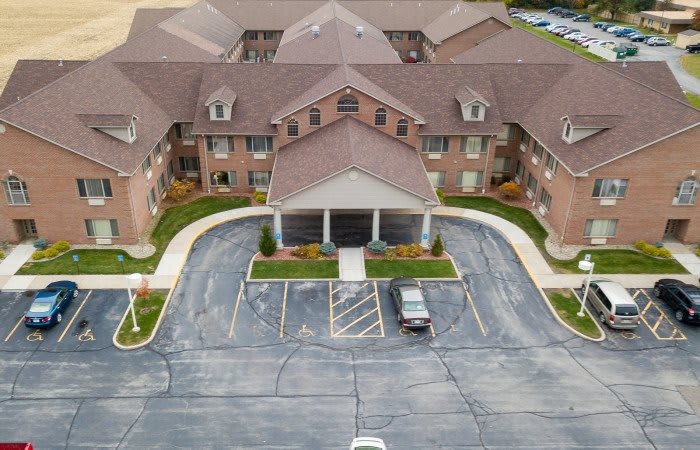 Aerial view of a residential building with a parking lot.
