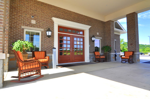A welcoming entrance featuring a brick facade and comfortable outdoor seating.