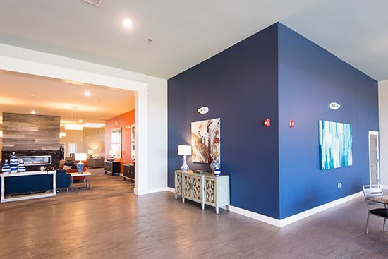 A modern interior space featuring elegant artwork, stylish furniture, and a warm ambiance.