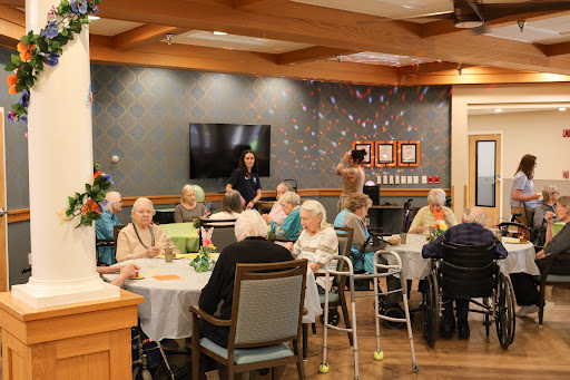A lively gathering of seniors in an activity room, enjoying social interactions and activities.