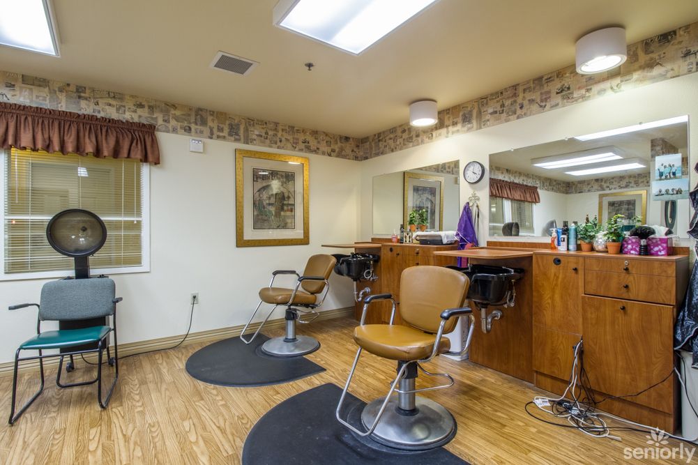 A cozy hair salon interior with styling chairs and mirrors.