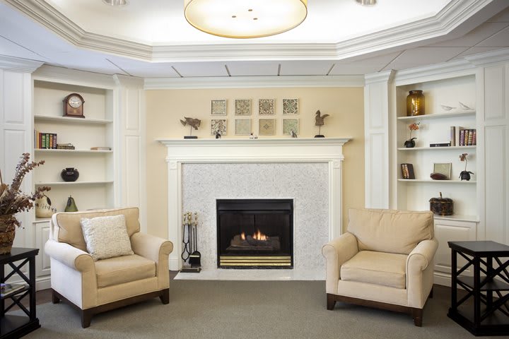 A cozy living room with a fireplace and comfortable armchairs.