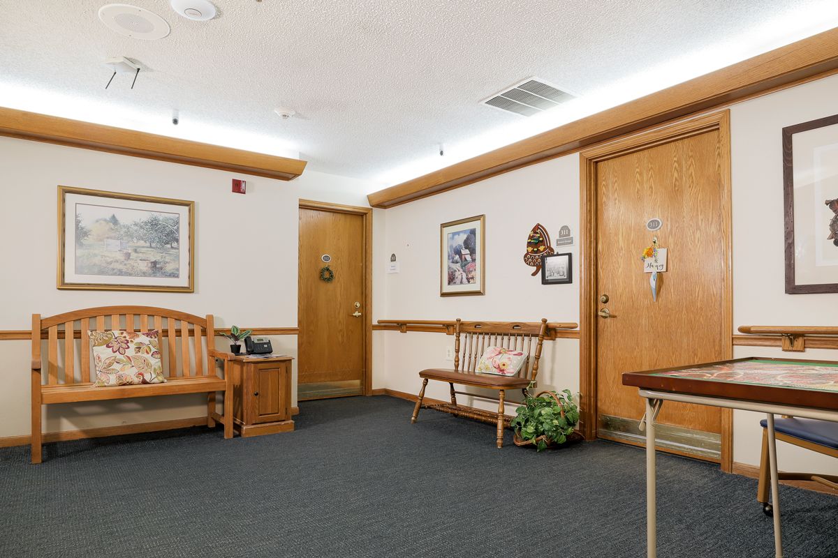 A quiet waiting room with seating and artwork on the walls.