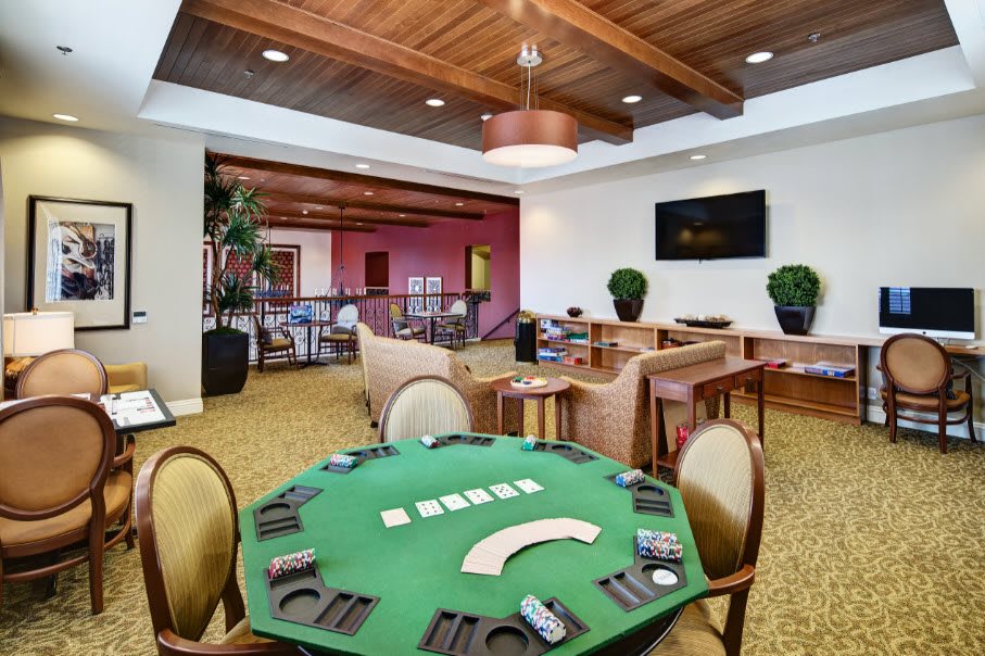 A stylish casino lounge featuring a poker table ready for a game.