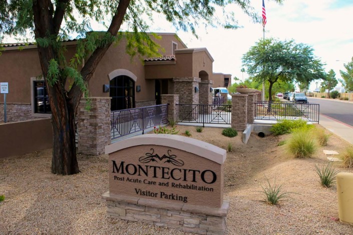 Entrance to Montecito with a visitor parking sign and landscaped surroundings.