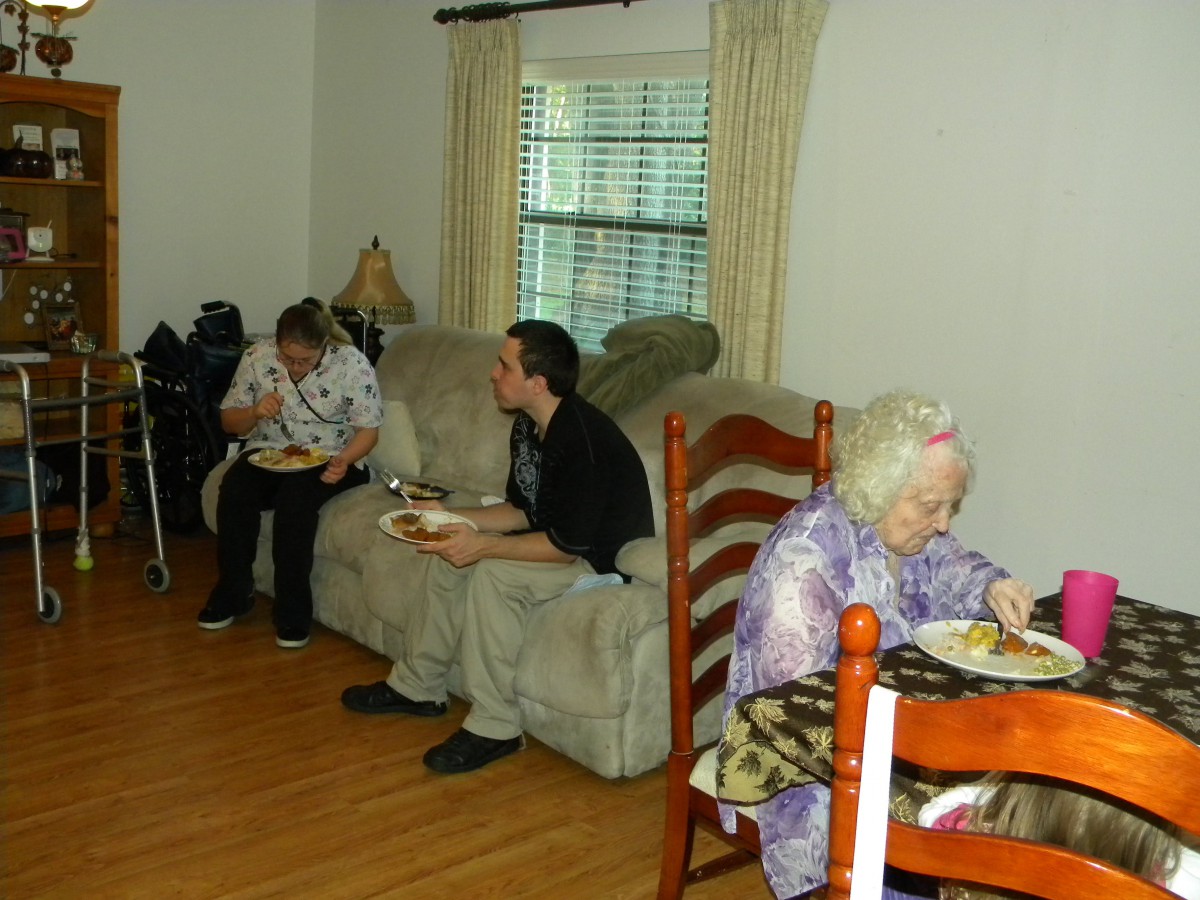 A family enjoying a meal together in the living room.
