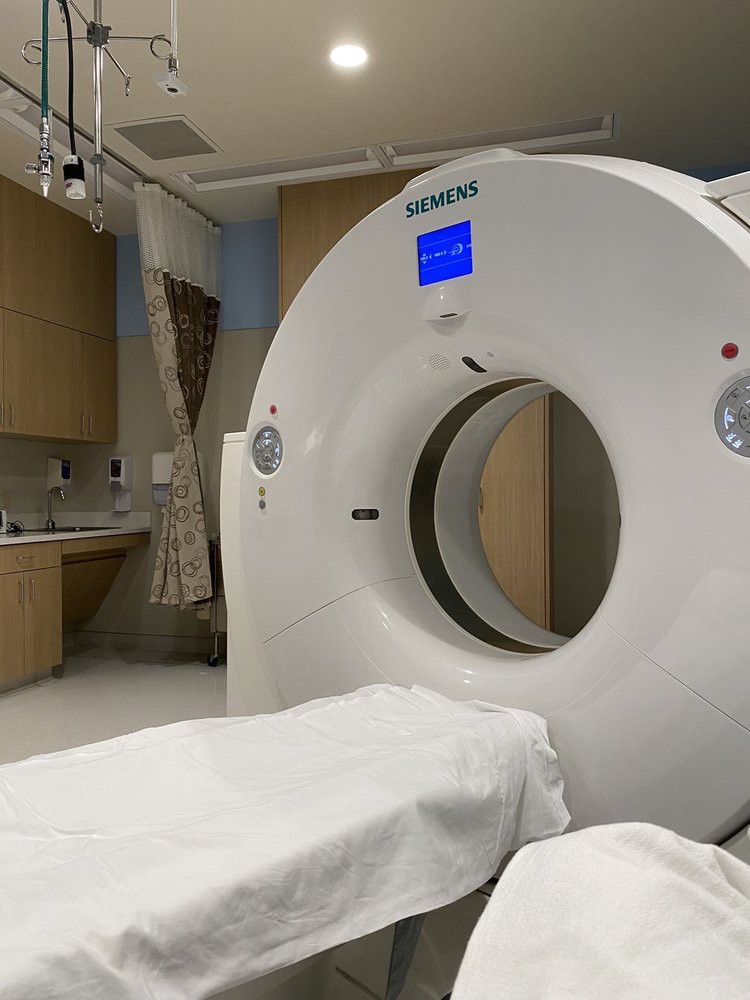 A CT scanner in a hospital radiology room, ready for use.