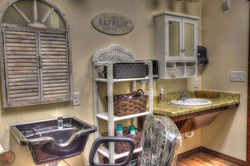 An inviting salon interior featuring a hair washing station and organized storage.
