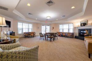 A spacious, well-lit room with multiple tables and chairs arranged in an inviting manner.