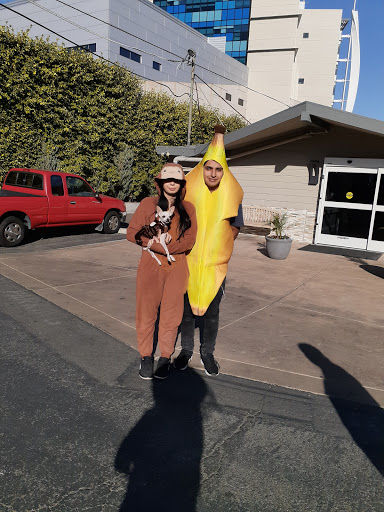 A playful moment featuring two individuals in humorous costumes, one dressed as a banana and the other resembling an animal.