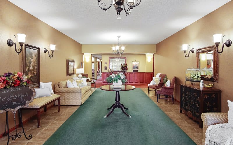 Elegant living room with classic furniture and chandelier.