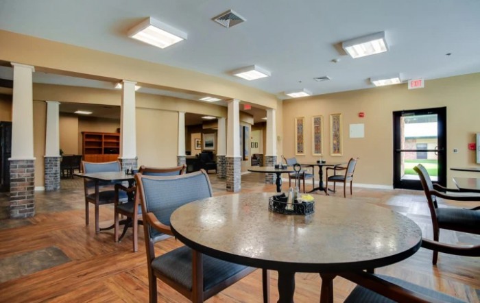 An empty dining area with tables and chairs arranged neatly.