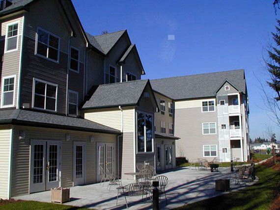 A multi-story residential building with outdoor seating.