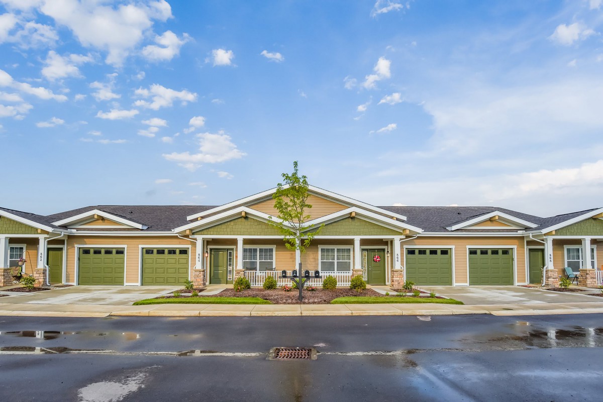 A modern duplex with a symmetrical design in a suburban neighborhood.