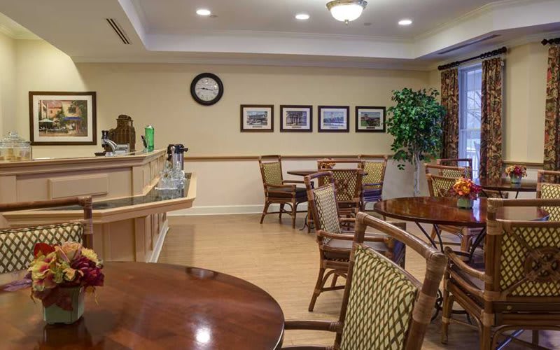 A cozy seating area with wooden furniture and decorative elements, resembling a small caf.