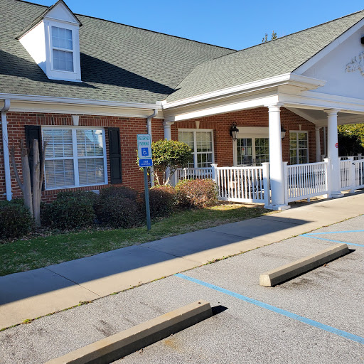 A charming residential building with a welcoming entrance and accessible parking.