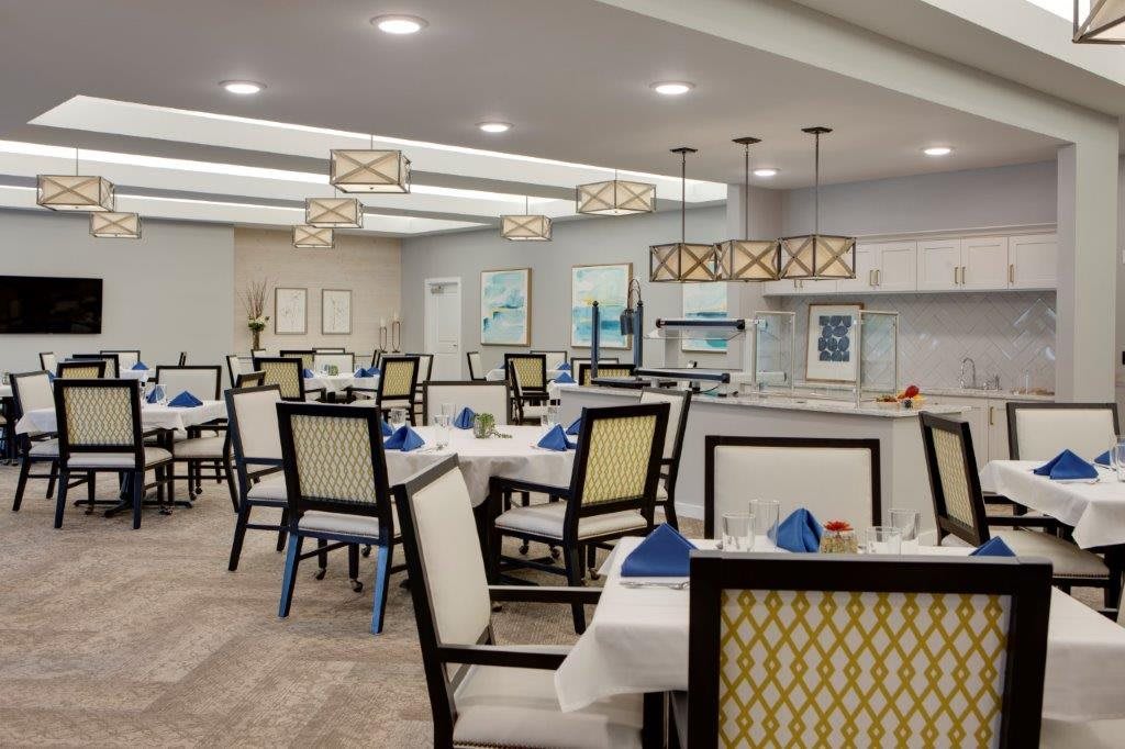 A modern dining room with neatly arranged tables and stylish lighting.