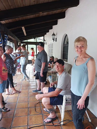 A lively gathering on a porch, with friends enjoying each other's company.