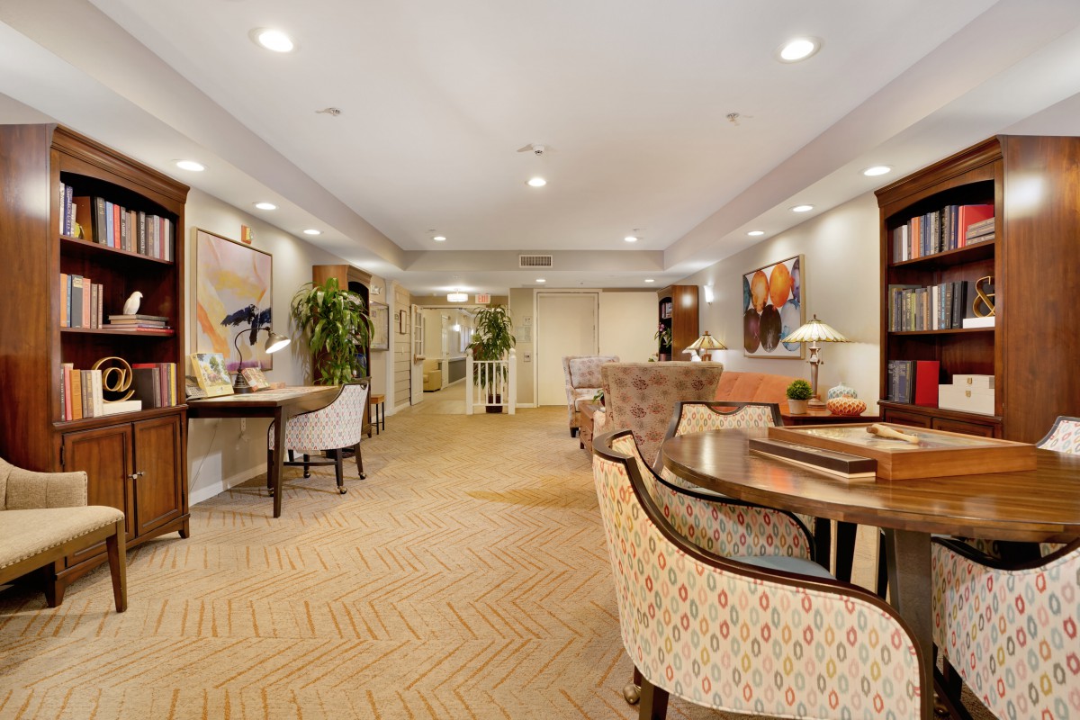 A spacious and elegantly decorated living room with comfortable seating and tasteful artwork.
