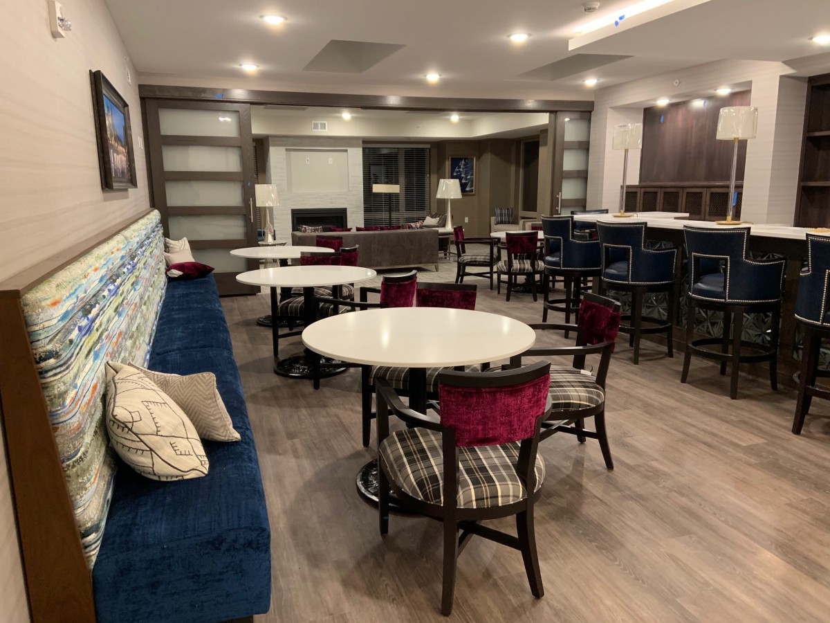A modern dining area with round tables and mixed seating options.
